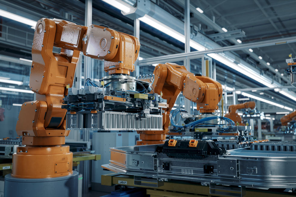 Orange industrial machines in use at a factory